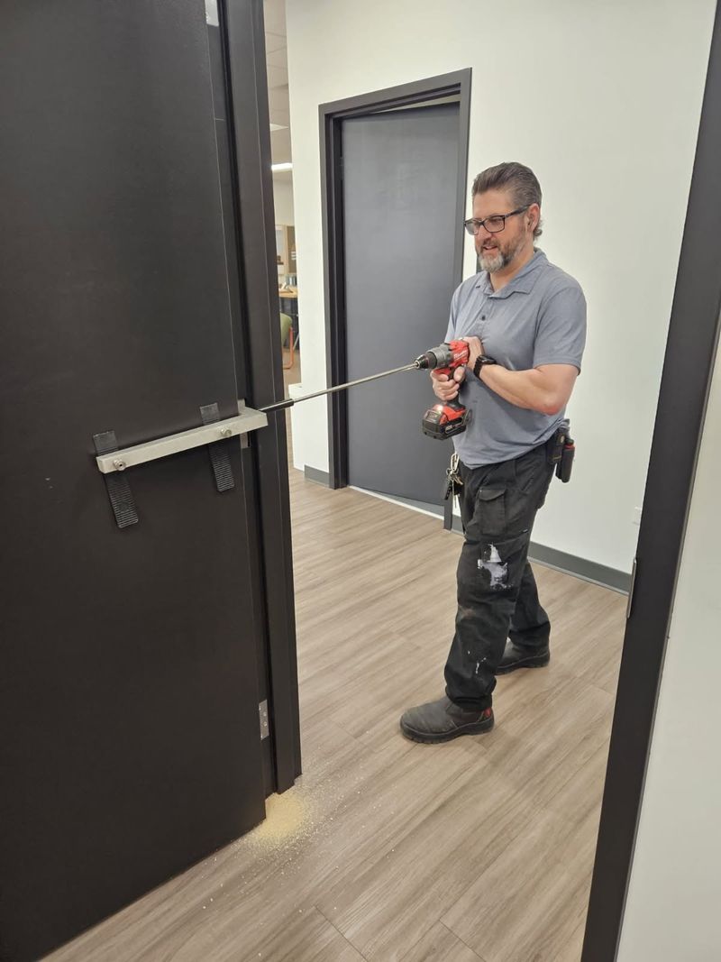 Scott Duboff drilling out a commercial door lock with a cordless drill