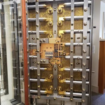 Engraved brass bank vault door with locking bolts and time locks